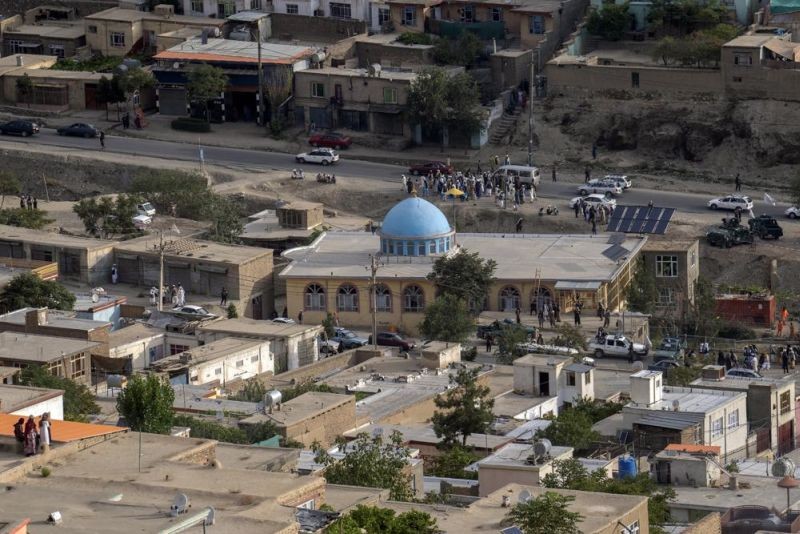 Taliban fighters and local residents gather around a mosque that has been bombed, in Kabul, Afghanistan, Thursday, Aug. 18. 2022. A bombing at a mosque in Kabul during evening prayers on Wednesday killed at least 10 people, including a prominent cleric, and wounded over two dozen, an eyewitness and police said. (AP Photo)