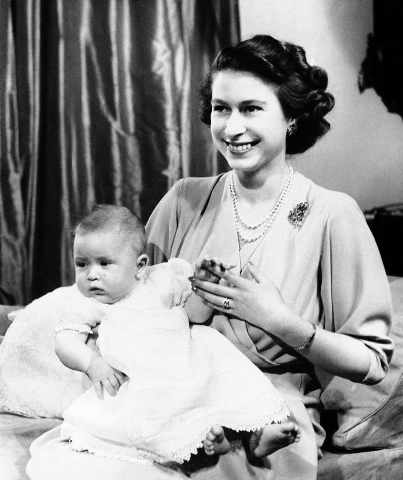 In this April 10, 1949 file photo, Prince Charles of Edinburgh, left, sits for a photo with his mother, Princess Elizabeth, in Buckingham Palace, London. (AP File Photo)