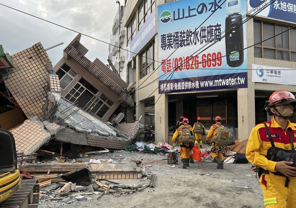 This photo provided by Hualien County fire department show firefighters in the search for trapped victims in a collapsed residential building following earthquake in Yuli township in Hualien County, eastern Taiwan, Sunday, Sept. 18, 2022. A strong earthquake shook much of Taiwan on Sunday, toppling at least one building and trapping two people inside and knocking part of a passenger train off its tracks at a station.(AP/PTI)