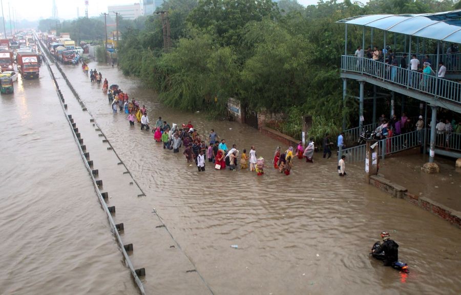 Gurugram: Commuters wade through the waterlogged Delhi-Gurugram Expressway service road after rainfall, in Gurugram, Thursday, Sept. 22, 2022. (PTI Photo)