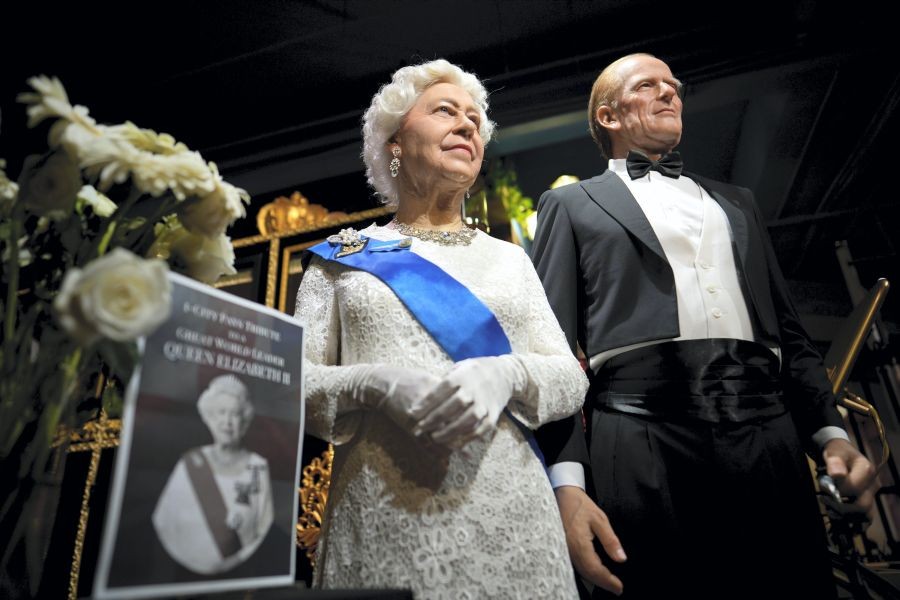 Kuala Lumpur: Flowers and a tribute are set up next to wax figures of the late Queen Elizabeth II and her husband Prince Philip, Duke of Edinburgh, at the i-City Red Carpet Wax Museum in Shah Alam, on the outskirts of Kuala Lumpur, Malaysia, Sunday, Sept. 11, 2022. AP/PTI Photo