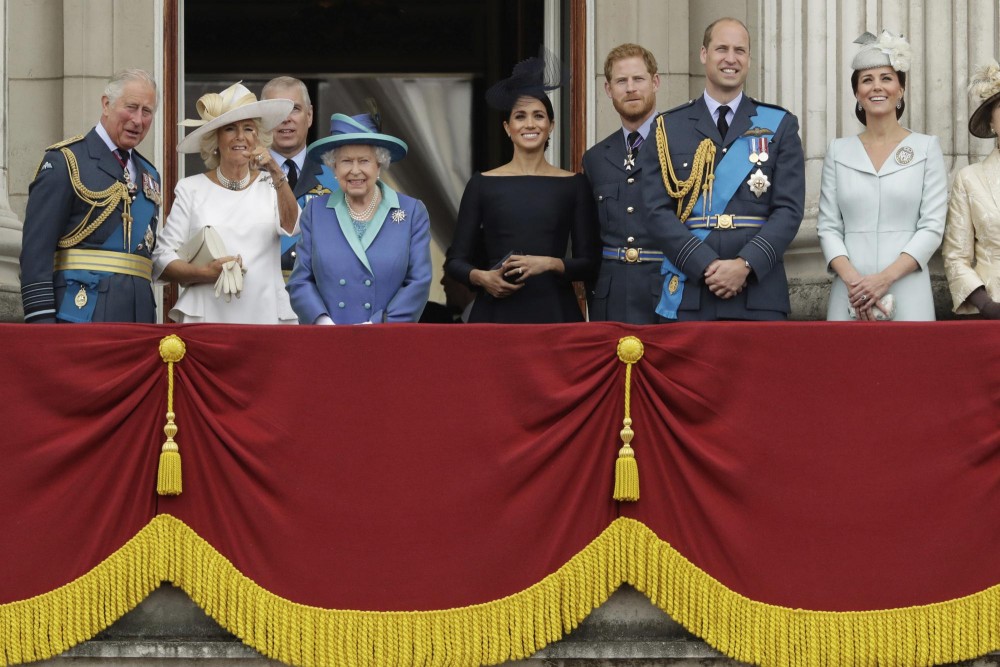 In this Tuesday, July 10, 2018 file photo, members of the royal family gather on the balcony of Buckingham Palace, with from left, Prince Charles, Camilla the Duchess of Cornwall, Prince Andrew, Queen Elizabeth II, Meghan the Duchess of Sussex, Prince Harry, Prince William and Kate the Duchess of Cambridge, as they watch a flypast of Royal Air Force aircraft pass over Buckingham Palace in London. (AP Photo/Matt Dunham, File)
