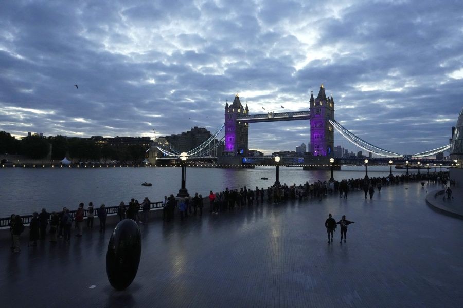 London: People walk in a queue past the Tower Bridge to pay their respect to the late Queen Elizabeth II during the Lying-in State, in Westminster Hall, in London, England, Friday, Sept. 16, 2022. The Queen will lie in state in Westminster Hall for four full days before her funeral on Monday Sept. 19.AP/PTI Photo