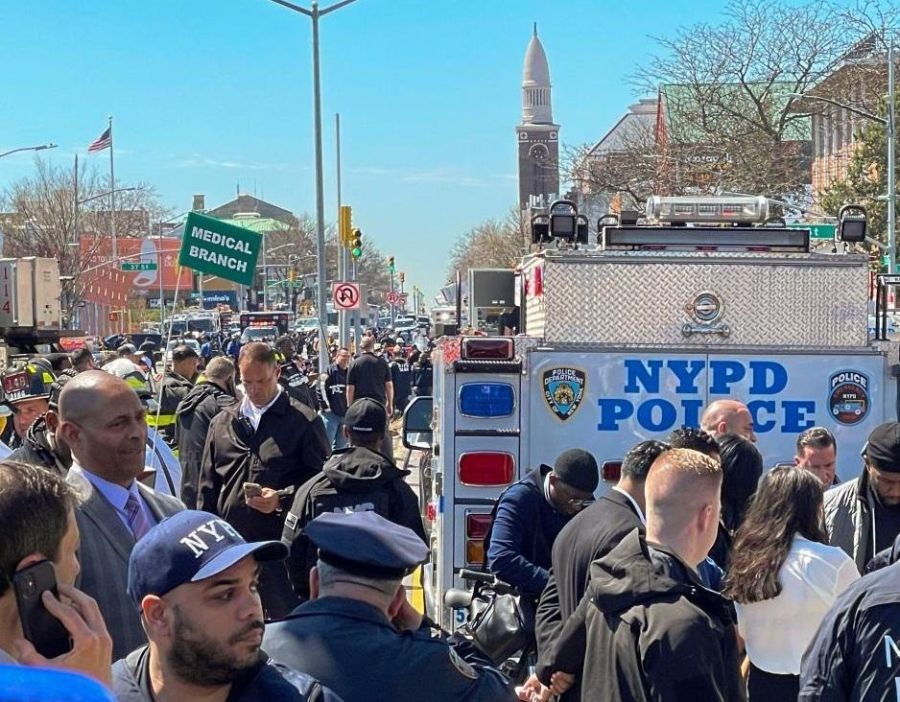 Photo taken with a mobile phone shows police and investigators working at a nearby street after a shooting took place at a subway station in Brooklyn, New York, the United States, on April 12, 2022. At least five people were shot and 13 were injured on Tuesday morning at the subway station in Brooklyn, local media reported, citing law enforcement sources. (Xinhua/Zhang Mocheng/IANS)