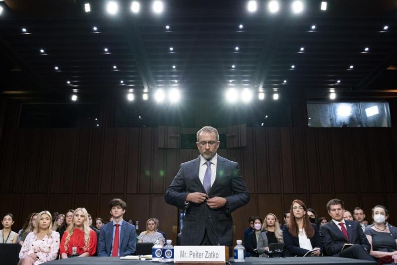 Twitter whistleblower Peiter Zatko buttons his jacket as he rises to be sworn in to testify to a Senate Judiciary hearing examining data security at risk on September 13, 2022, in Washington. (AP Photo)