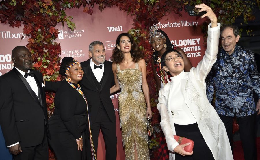 Honoree Maria Ressa takes a selfie with George Clooney, from third left, and Amal Clooney, and honorees from left, Oumda Alfateh Younous Haroun, Wanjiru Wahome, Josephine Kulea and Albie Sachs at the Clooney Foundation for Justice Albie Awards at The New York Public Library on Thursday, Sept. 29, 2022, in New York. AP/PTI