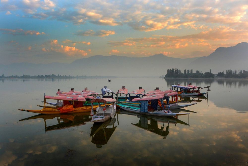 Srinagar: Shikaras parked in Dal Lake during sunrise, in Srinagar, Friday, Sept. 23, 2022. (PTI Photo)