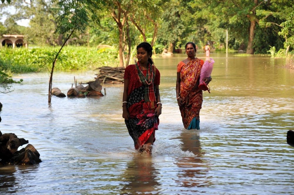 Kolkata: Villegers stand in flood affected area in Howrah District West Bengal on Sunday october 03, 2021.(Photo/IANS)
