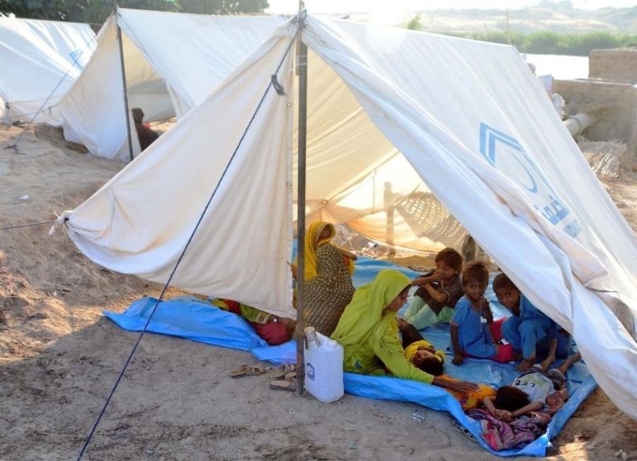 A flood-affected family is seen at a makeshift tent on the outskirts of Hyderabad, Pakistan, on Oct. 3, 2022. (Str/Xinhua/IANS)