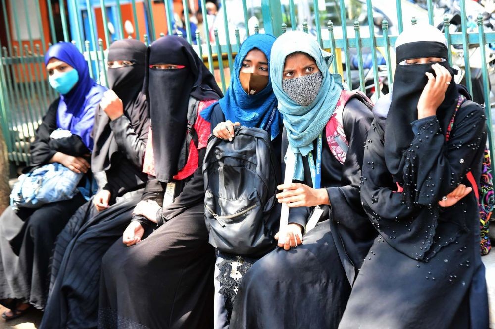 Bengaluru:Muslim students wearing Hijab were stopped by policemen from entering Government PU College Yelahanka, amid Karnataka High Courts interim order restraining students from wearing religious symbols inside the classroom, in Bengaluru on Friday 18th February 2022.(PHOTO:IANS)