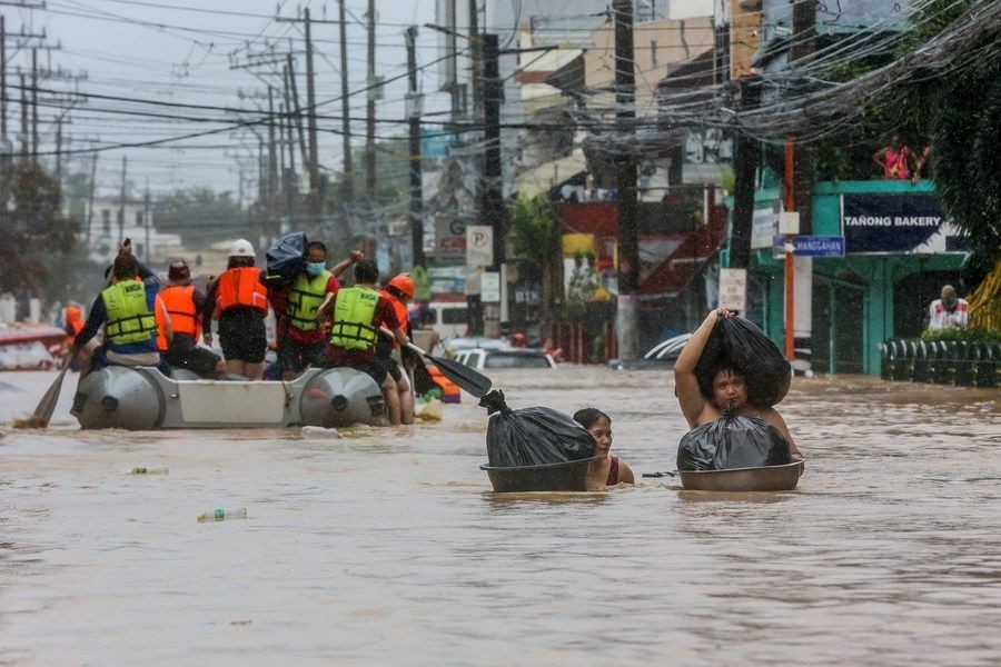 Philippines, Nov. 12 (Xinhua) --  Residents carry their belongings through the flood brought by typhoon Vamco in Manila, the Philippines on Nov. 12, 2020. (Xinhua/Rouelle Umali/IANS)
