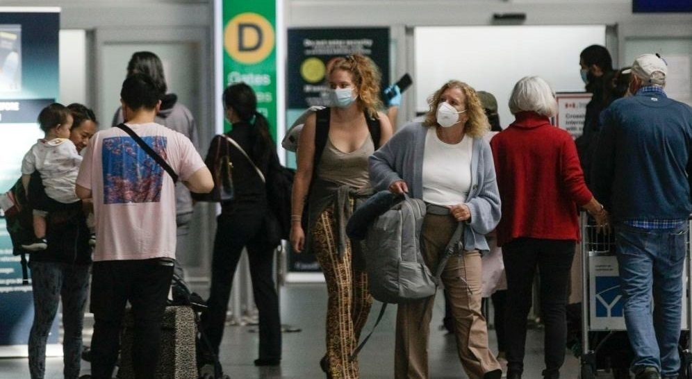 Travelers with face masks are seen at Vancouver International Airport in Richmond, Canada, on Sept. 26, 2022. (Photo by Liang Sen/Xinhua/IANS)