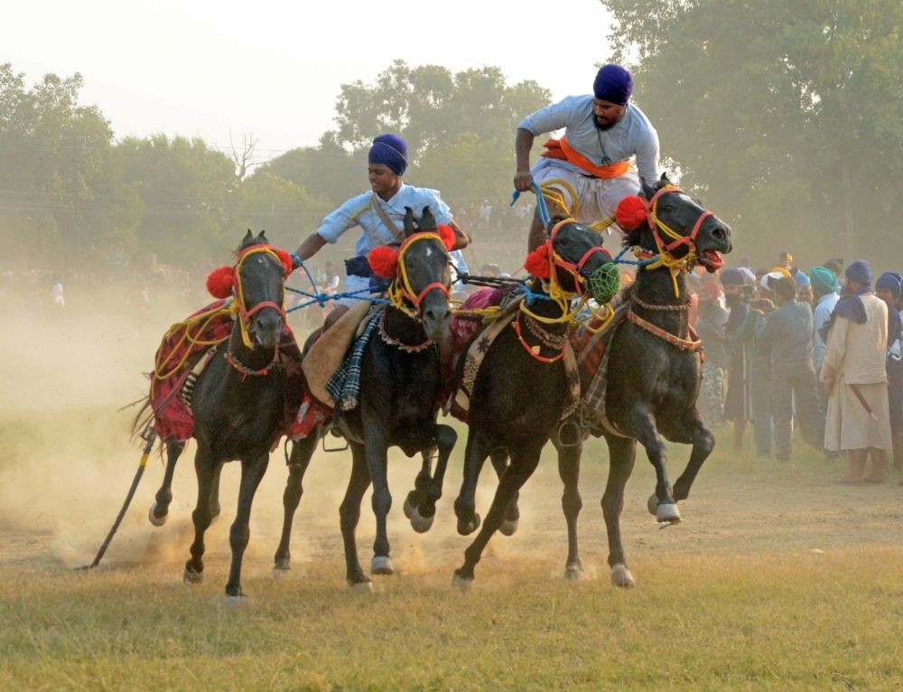 Amritsar: Nihang Sikh warriors ride horses during a Fateh Diwas celebration a day after the Hindu festival Diwali, in Amritsar on Tuesday, Oct. 25, 2022. (Photo: Pawan sharma/IANS)