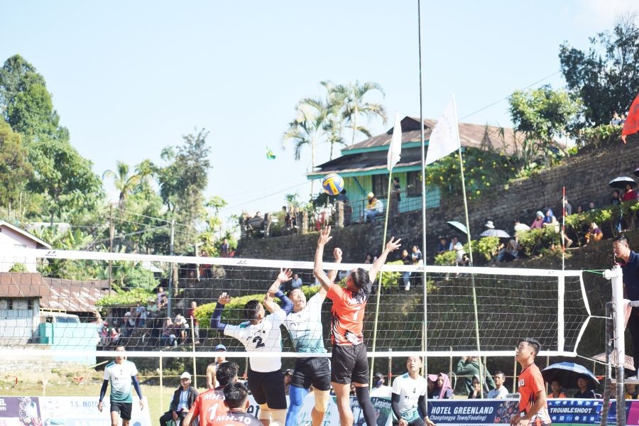 MH10 Kohima Senior team in red jersey in action against Changtongya Volleyball Association A.