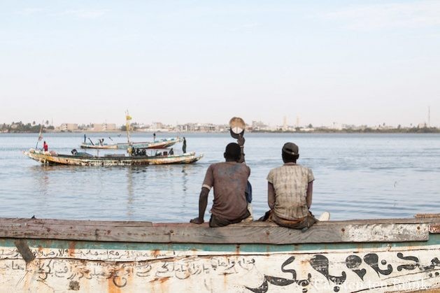 Illegal fishing is not only affecting the environment but impacting on the livelihoods of millions of fishers are also at stake, according to a new report. Here residents wave to fishers on boats in Saint Louis, Senegal. (Photo Courtesy: Carsten ten Brink/Flickr)