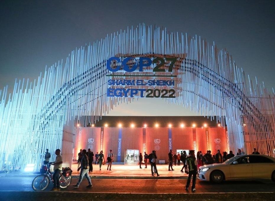 A man walks past a board showing the 27th Conference of the Parties of the United Nations Framework Convention on Climate Change (COP27) in Sharm El-Sheikh, Egypt, Nov. 5, 2022. (Xinhua/Sui Xiankai/IANS)