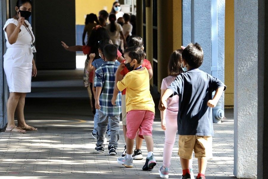 A teacher guides students to line up for their snacks at Montrara Ave. Elementary School in Los Angeles, California, the United States, on Aug. 16, 2021. (Xinhua/IANS)