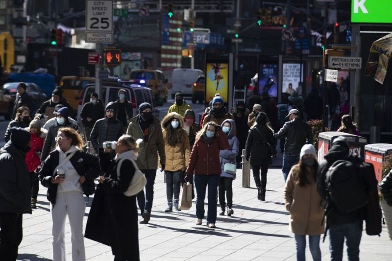 People walk on the street on Times Square in New York, the United States, Feb. 14, 2022. (Xinhua/Wang Ying/IANS)