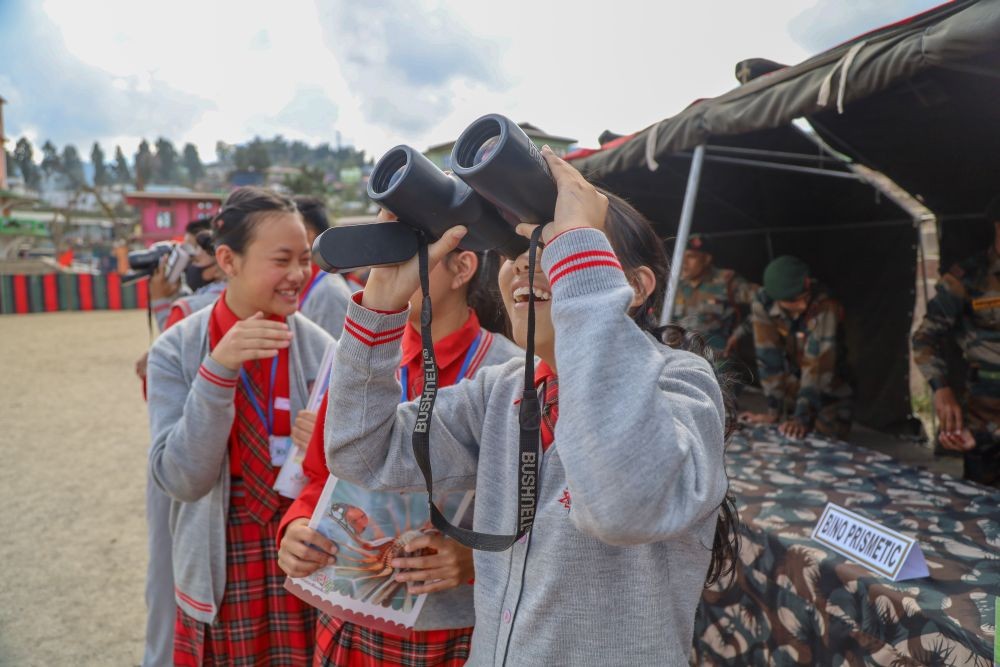 An NCC cadet peers through a binocular during the 28 AR’s equipment display at Parade Ground, Tuensang on November 7. (Morung Photo)