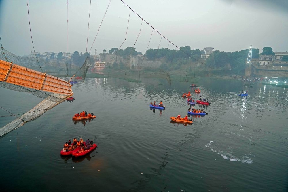 Morbi: NDRF team during rescue operation at the Machchu river next to a cable bridge that collapsed on Sunday night, in Morbi district in the wee hours of Monday, Oct. 30, 2022. At least 141 died after the cable bridge collapsed in Morbi on Sunday night. (IANS Photo/Siddharaj Solanki)