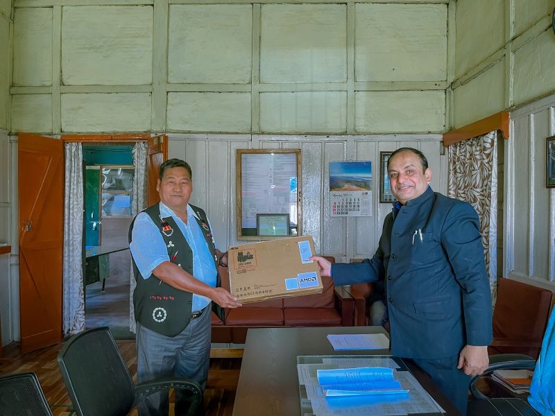 N Y Choba, Executive Chairman, CKS handing over the laptop to Sunil Thakur, Senior Principal, GHSS, Tuensang. (Morung Photo)