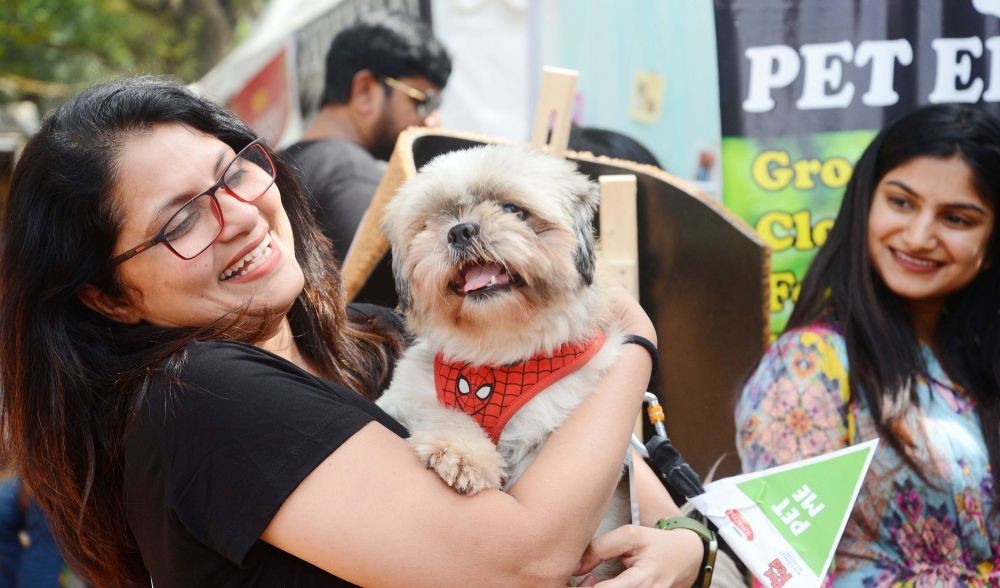 Bengaluru:Pet lovers participate with their pet during a Pet Fed Bengaluru 2022 dog and cat show organised by Just Dogs at Jayamahal palace, in Bengaluru on Saturday 19th November 2022.(PHOTO:IANS)