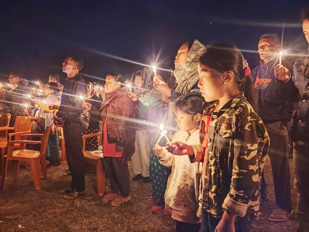 Two young girls pray along with village elders as citizens of Oting gather to pause, reflect and implore for justice during the first anniversary of Oting incident at the public ground Oting on December 4. (Morung Photo by Special Arrangement)
