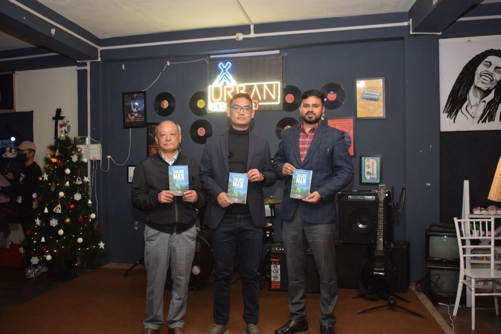 Sentilong Ozukum, author of Teacher Man with Shashank Pratap Singh, IAS, DC Mokokchung and Rev Takatemjen after the release of the book at Urban Hub café, Mokokchung on December 1. (Morung Photo)