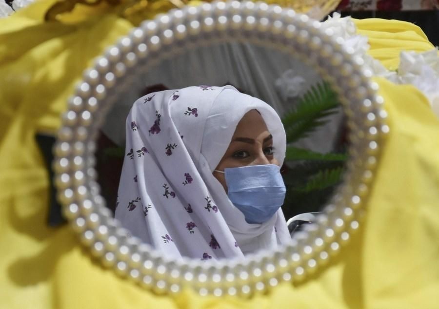 Balkh Aug. 8, 2020 (Xinhua) -- Photo taken on Aug. 6, 2020 shows the reflection of an Afghan bride in a mirror during a collective wedding party in Mazar-i-Sharif, capital of the northern Balkh province, Afghanistan. At a rare social event 82 couples held a collective wedding party in a local hotel in Mazar-i-Sharif city on Thursday, organizer and supporter Zahra Amiri said. The aim of collective marriage, according to Amiri, is to avoid splendid wedding parties to save money for married families to run their daily life after marriage. (Photo by Kawa Basharat/Xinhua/IANS)