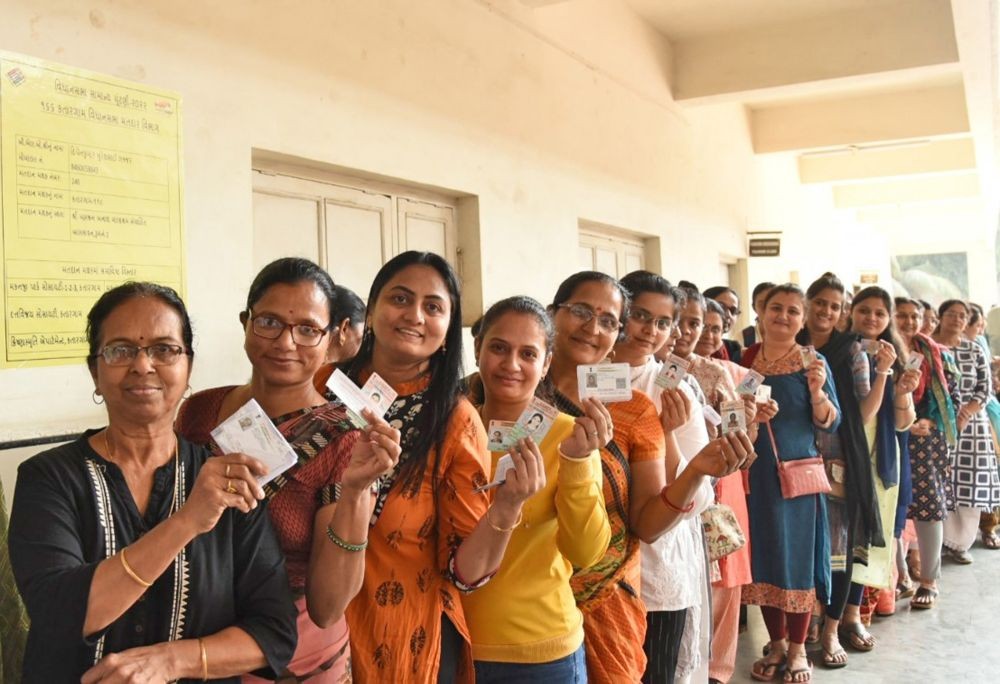 Surat: Voters standing in a queue to cast their votes at a polling booth during the first phase of Gujarat Assembly Election at Katargam lokhandwala school, in Surat on Thursday, December 01, 2022. (Photo: PIB/IANS)