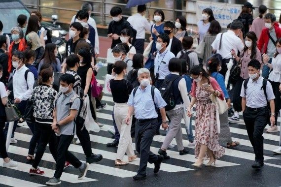 Pedestrians walk across a street in Tokyo, Japan on July 8, 2021. (Photo by Christopher Jue/Xinhua/IANS)