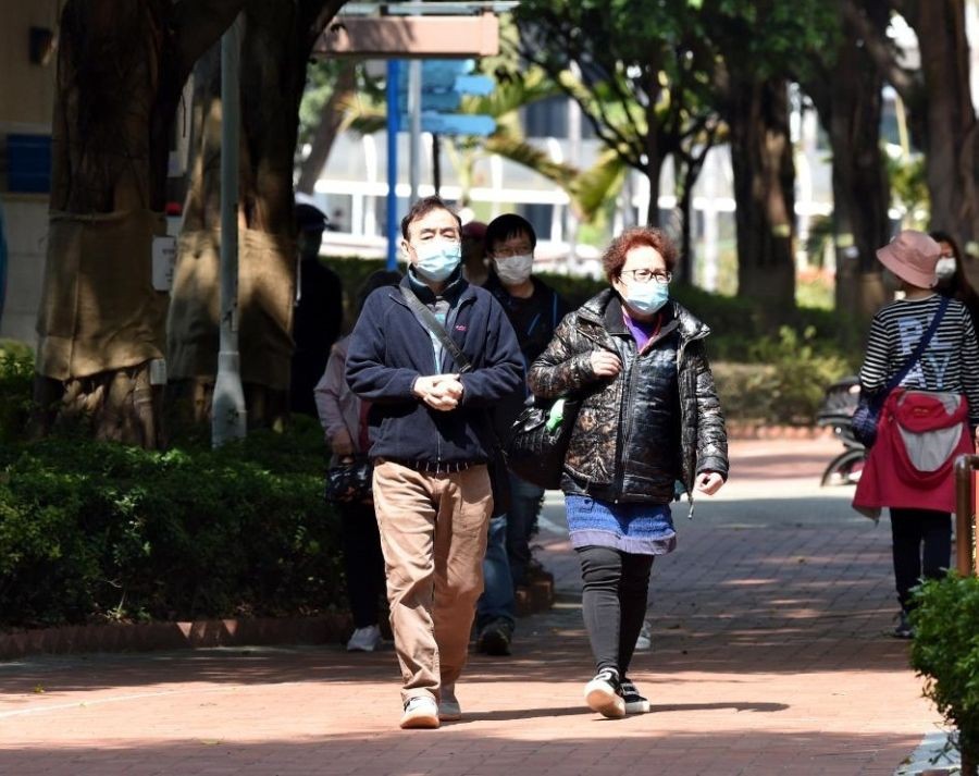 People wearing masks walk on road in Hong Kong, Feb. 27, 2022. (Xinhua/Lo Ping Fai/IANS)