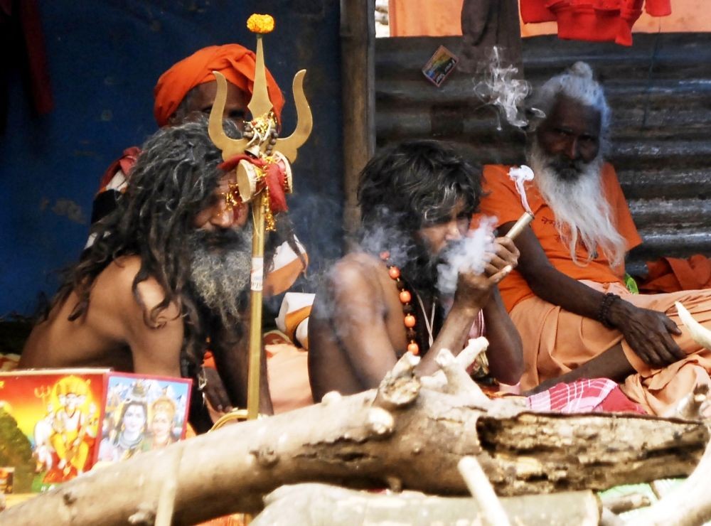 A Sadhu smoking a chillum at Babughat transit camp ahead of the Gangasagar Mela on occasion of Makar Sankranti, in Kolkata on January 4, 2023.  ( IANSPhoto)