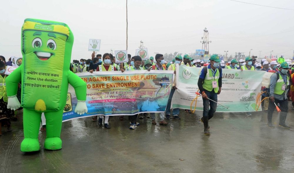 Gangasagar: Cleaning and sanitizing staff take part in a campaign against the use of plastic to save the environment during Gangasagar Mela in Gangasagar island on Friday, January 13, 2023. (Photo: Kuntal Chakrabarty/IANS)