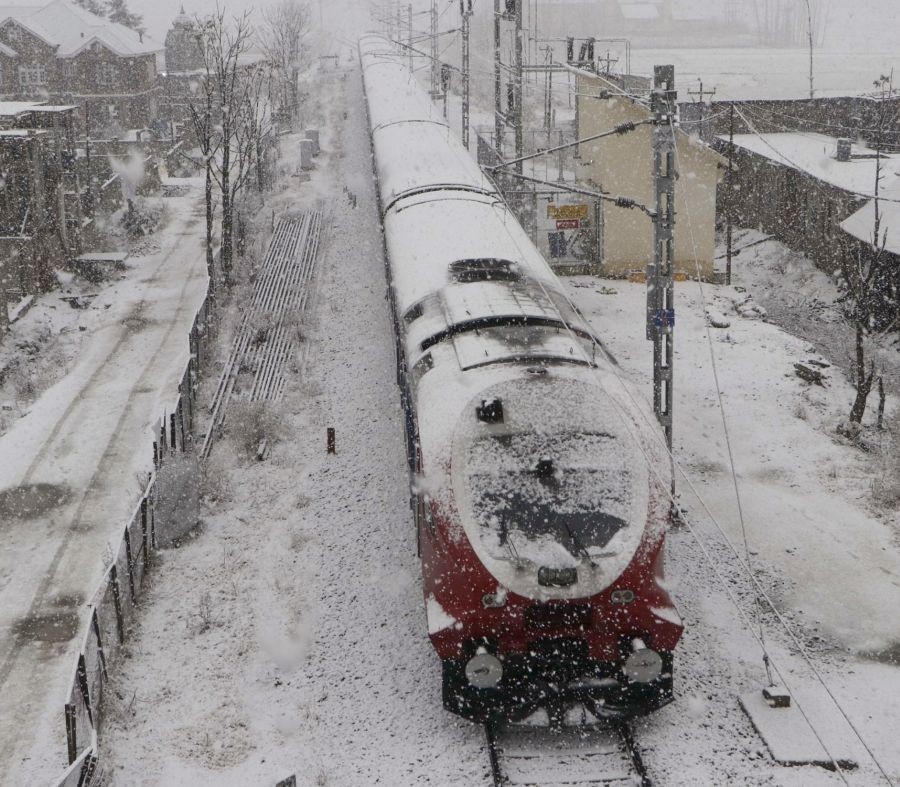 Anantnag: A train makes its way through snow-covered track during a fresh snowfall in Anantnag district  on Friday, Jan. 13, 2023. (Photo: Nisar Malik/IANS)