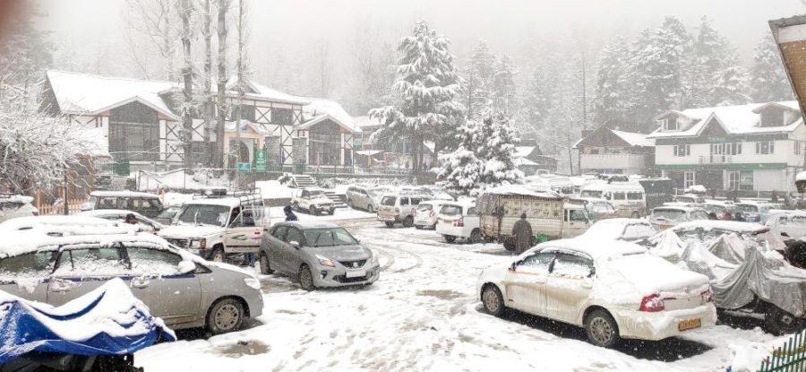 Baramulla: Vehicles covered with snow park near hotels during heavy snowfall at Tangmarg area of Baramulla district on Wednesday, Jan. 11, 2023. (Photo: Nisar Malik /IANS)