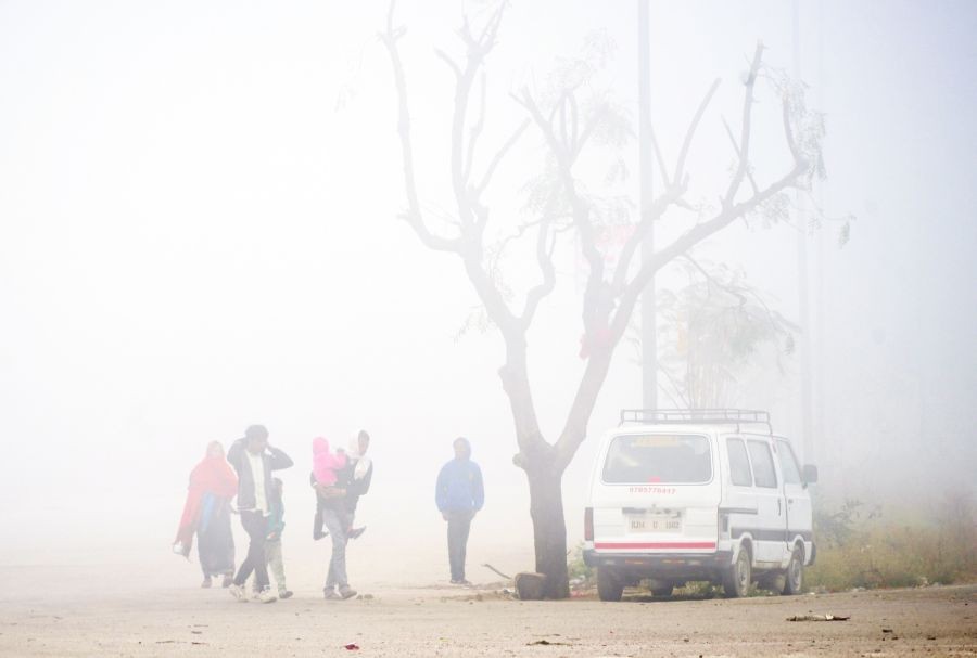Jaipur: People walk past amid dense fog covering the area on a cold winter day, in Jaipur on Tuesday, Jan. 03, 2022. (Photo: IANS/Ravishankar Vyas)
