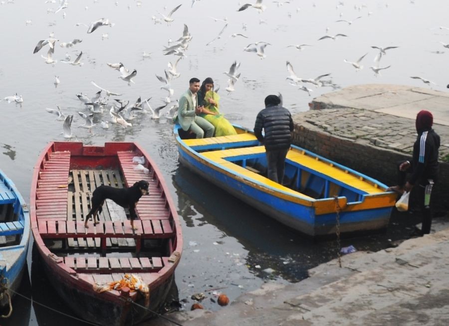 New Delhi: Boats anchor to the bank of river Yamuna as migratory birds fly over on a cold day, in New Delhi on Monday, Jan. 09, 2023. (Photo: Qamar Sibtain/IANS)