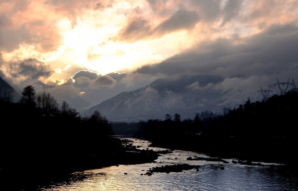 Baramulla : A view of flaming clouds at sunset over the lake, in Baramulla district on Saturday, Feb 11, 2023. (Photo: Nisar Malik /IANS)