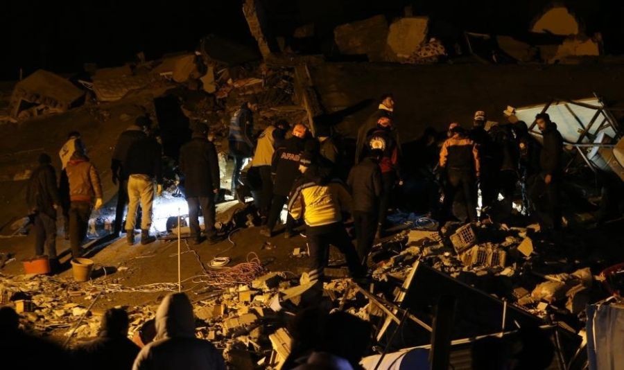 People search for survivors among the rubble of a building destroyed in a powerful earthquake in Pazarcik District, Kahramanmaras Province, Turkey, on Feb. 6, 2023. TÃƒÂ¼rkiye's Disaster and Emergency Management Authority (AFAD) has raised the death toll from Monday's powerful earthquakes to 2,316, as the rescue teams are racing against time to save people trapped under the rubble in cold and rainy weather. (Photo by Mustafa Kaya/Xinhua)