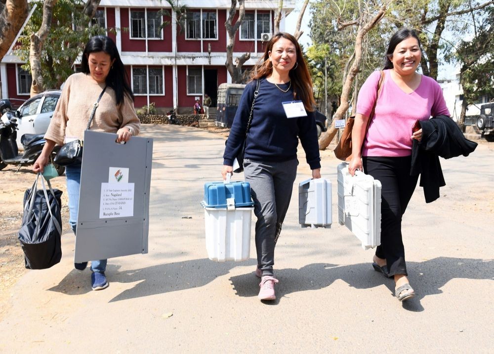 Dimapur: Women polling officials with electronic voting machine (EVM) and other election materials head towards their respective polling stations for the Meghalaya Assembly elections 2023, in Dimapur, Nagaland on Sunday, February 26, 2023.(Photo:IANS/Twitter)
