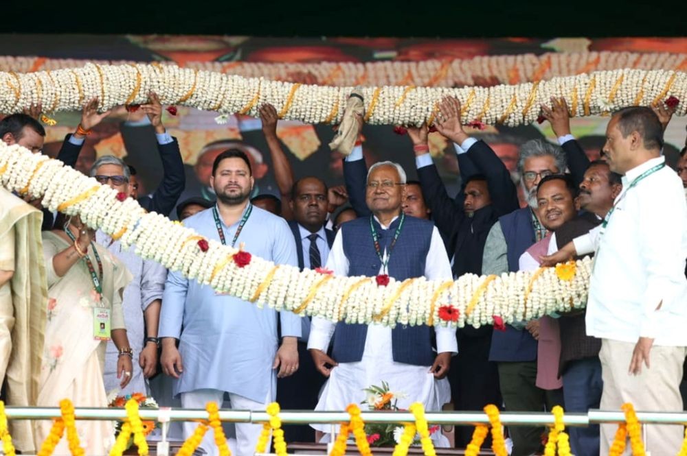 Purnia : Bihar Chief Minister Nitish Kumar and Deputy CM Tejaswi Yadav garlanded by party leaders during a public meeting at Rangbhoomi ground in Purnia on Saturday, Feb 25, 2023. (Photo:IANS)
