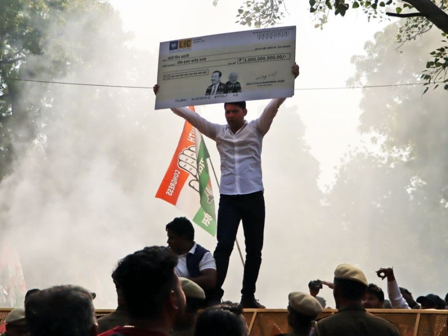 New Delhi: An Indian Youth Congress member holds a replica of a cheque staging a protest over Adani row, at Jantar Mantar in New Delhi on Monday, Feb. 06, 2023. (Photo: Wasim Sarvar/IANS)