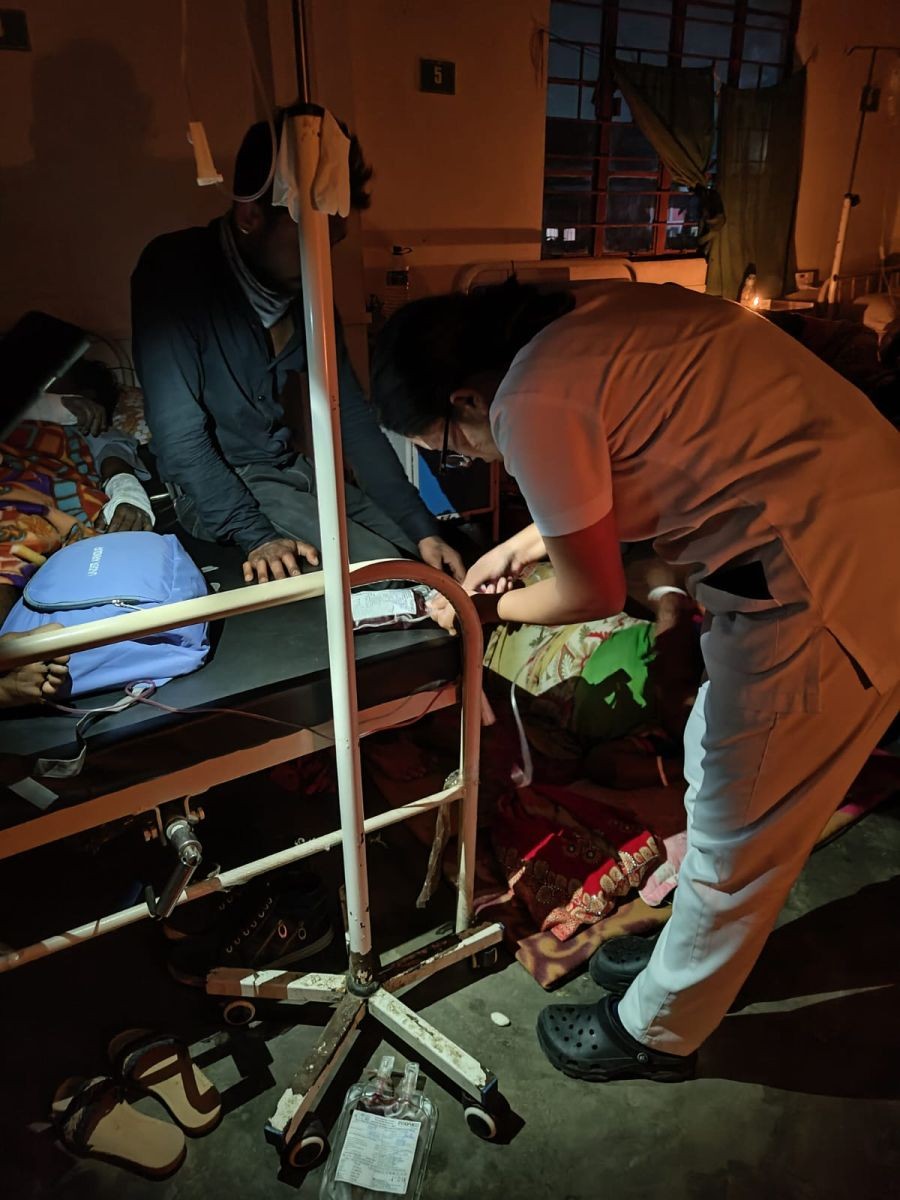 A nurse treating a patient in candle light at the District Hospital Dimapur on February 18. (Photo Courtesy: Nagaland Pradesh Congress Committee)