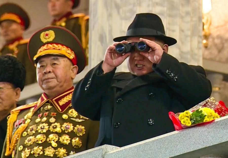 Pyongyang:North Korean leader Kim Jong-un (C) uses binoculars to watch a military parade at Kim Il Sung Square in Pyongyang on the night of Feb. 8, 2023.(Yonhap/END/IANS)