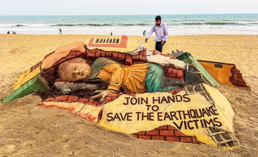 Puri: International sand artist Sudarshan Patnaik creates a sand art on Turkey earthquake at Puri sea beach on Thursday, Feb. 09, 2023. (Photo: Biswanath swain/IANS)