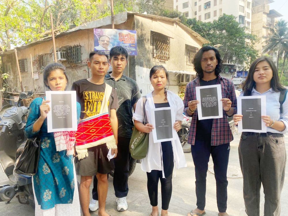 Tiapong Tzudir with his friends from university putting up posters against racial discrimination in Mumbai.