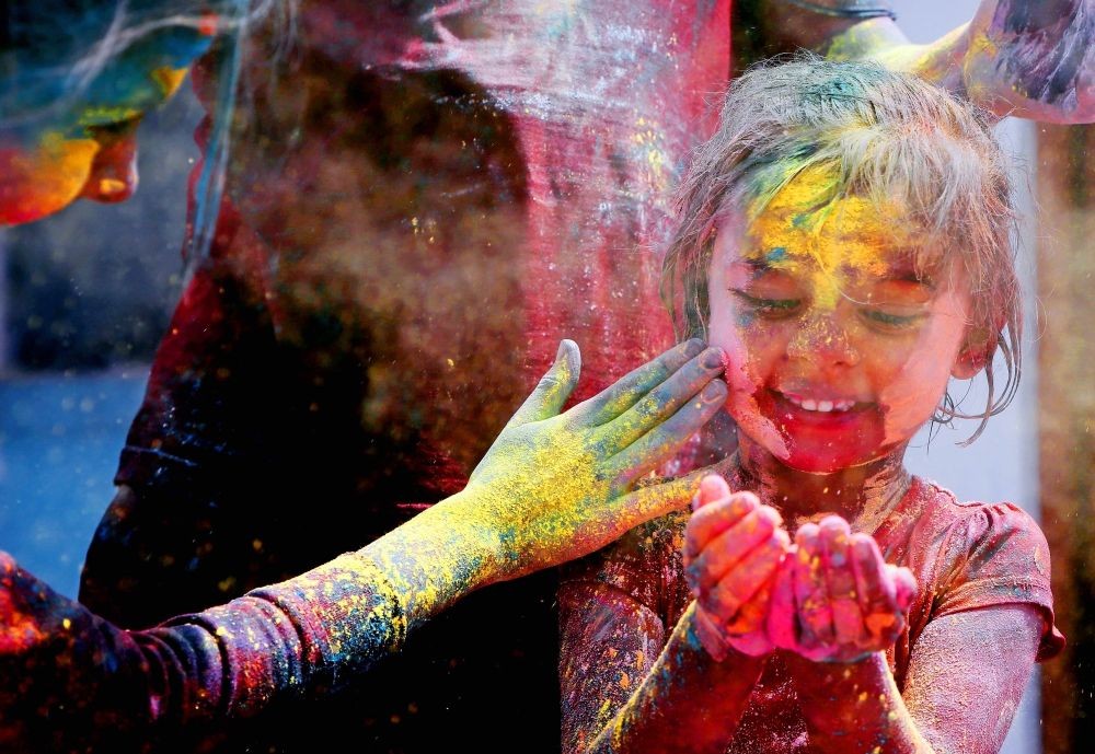 Bengaluru: A girl smeared in colour celebrates Holi festival in Bengaluru on Tuesday, March 07, 2023. (Photo: Dhananjay Yadav/IANS)