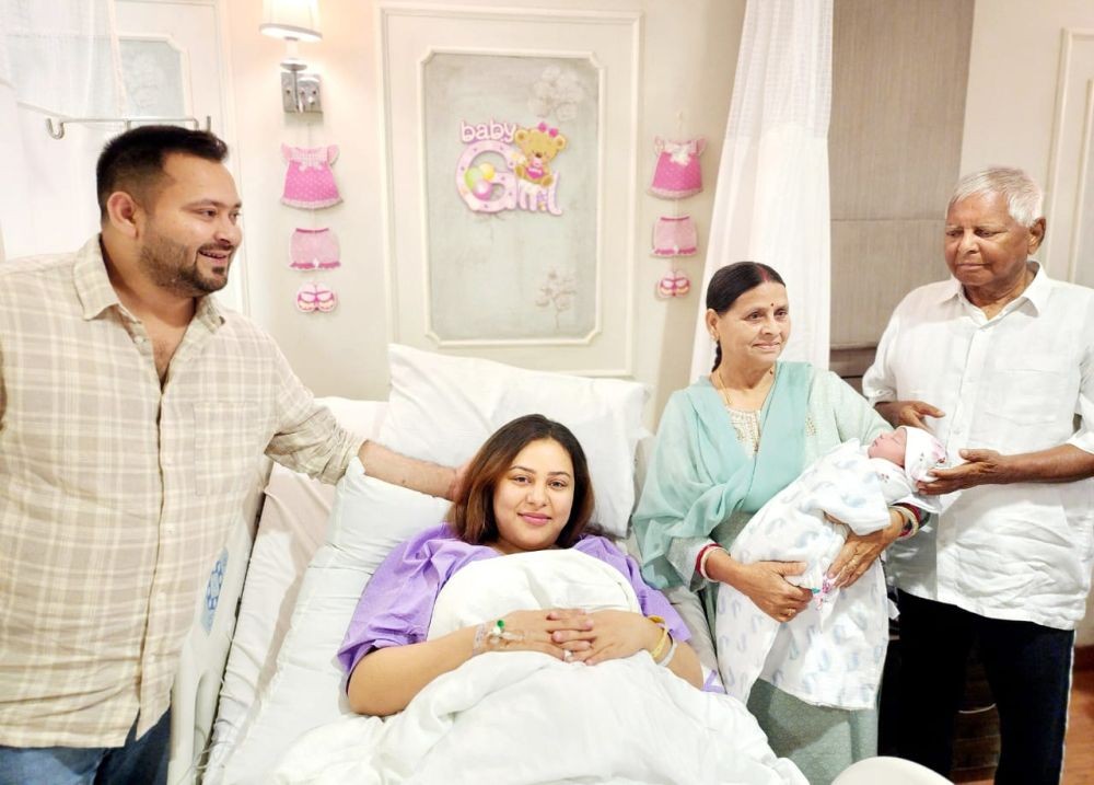 Patna: RJD Chief Lalu Prasad Yadav and former CM Rabri Devi with their newly born granddaughter on March 27, 2023. (Photo:IANS/Twitter)