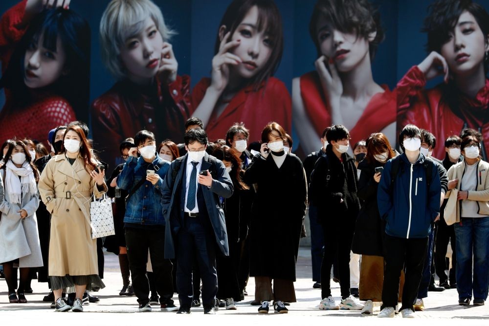 People wearing masks cross the famous scramble intersection near Shibuya Station in Tokyo on March 11. The Japanese government will lift the coronavirus state of emergency for Summer Olympics host city Tokyo on Sunday as planned, despite concerns about a recent climb in infections. Photo: James Matsumoto/SOPA Images via ZUMA Wire/dpa/IANS